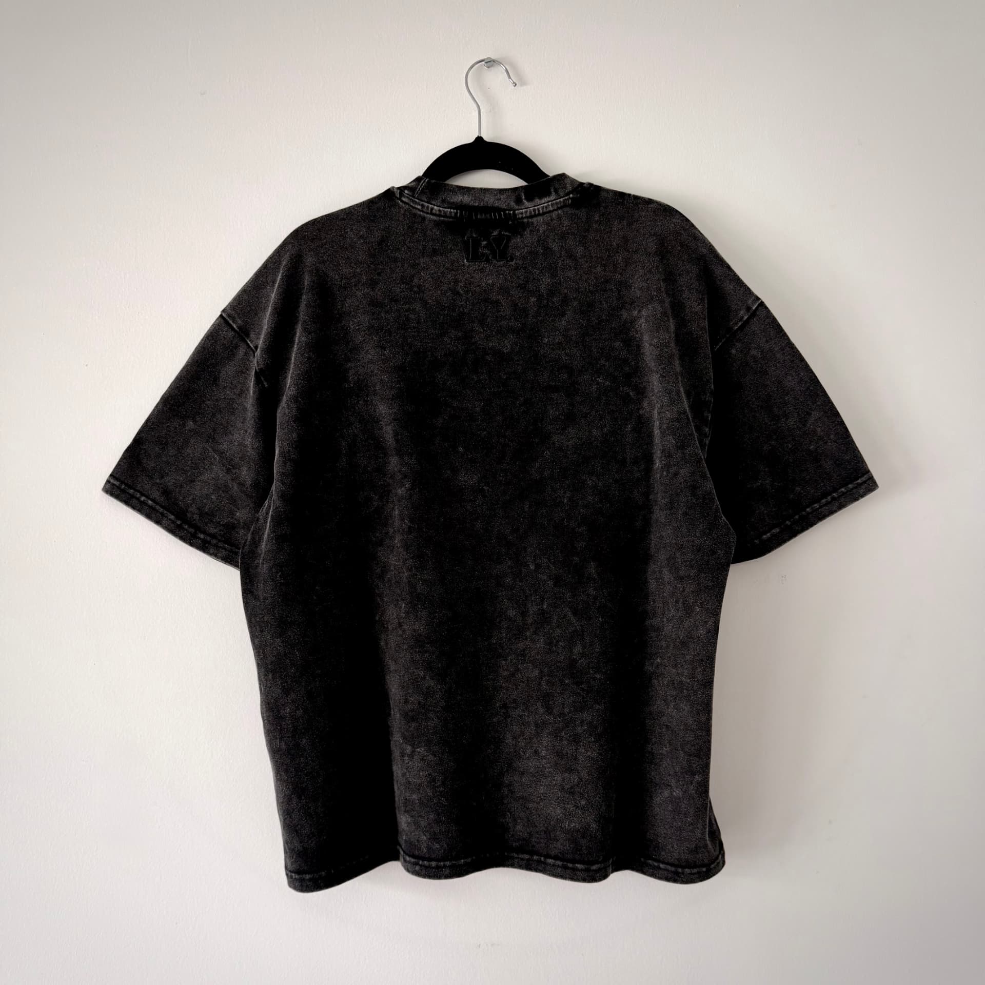 Back view of the L.EGACY. blank tee in washed black
